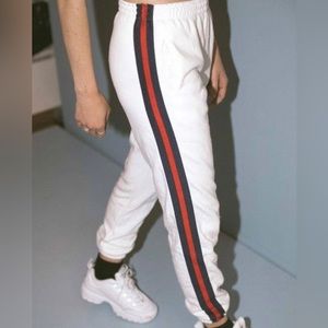 Brandy Melville. White jogger, red and navy blue stripes on the side. One size